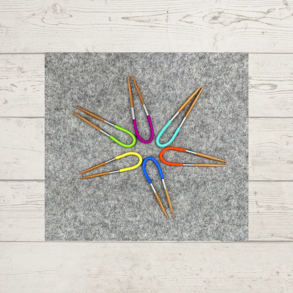 An assortment of solid-colored Flox Multi-tools, arranged in a star shape