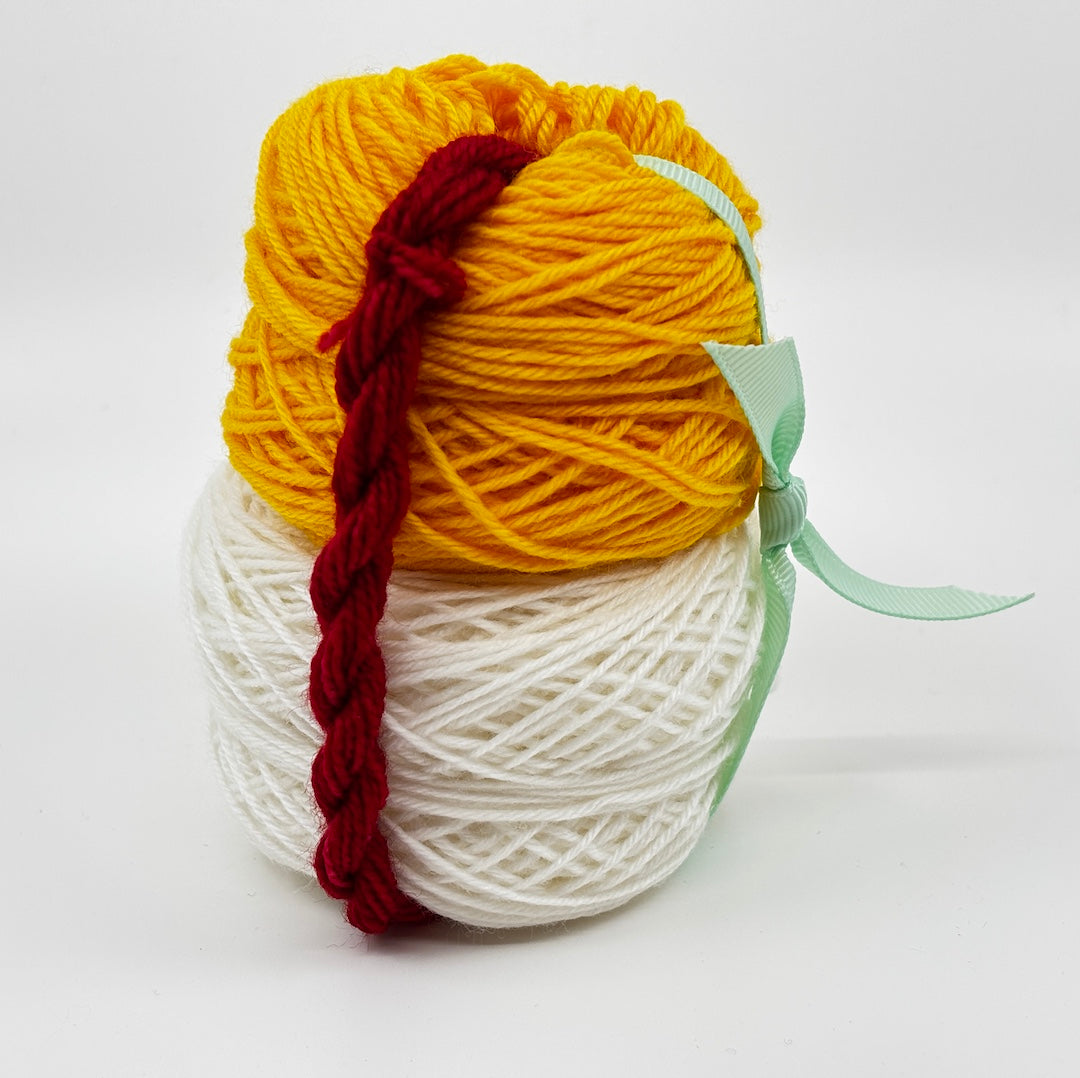 Picture shows kit, which includes mini-skeins of yellow, white, and red sock yarn