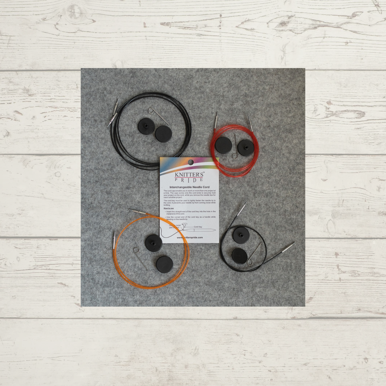 Knitter's Pride Interchangeable Needle Cables, shown in various sizes and colors, with keys and end caps