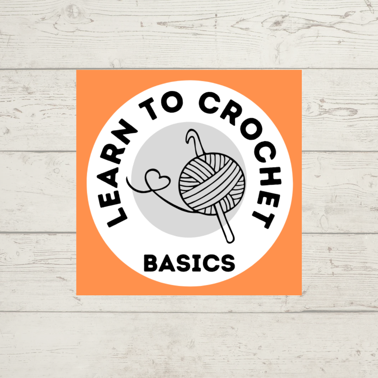 Learn to Crochet Basics class -- picture shows a ball of yarn, the tail forming a heart, with a crochet hook