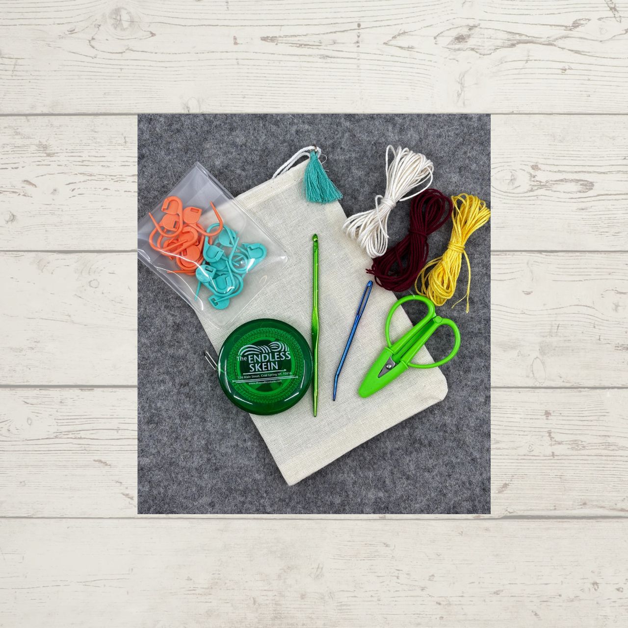 Essentials Notions Kit, which includes a measuring tape, scissors, a fix-it tool, locking stitch markers, a darning needle, and some cotton thread