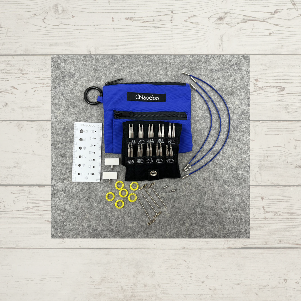 ChiaoGoo TWIST Shorties Interchangeable Knitting Needle Set, in blue (US 4-8), showing needle tips, cables, end stoppers, tightening keys, connectors, stitch markers, and needle gauge