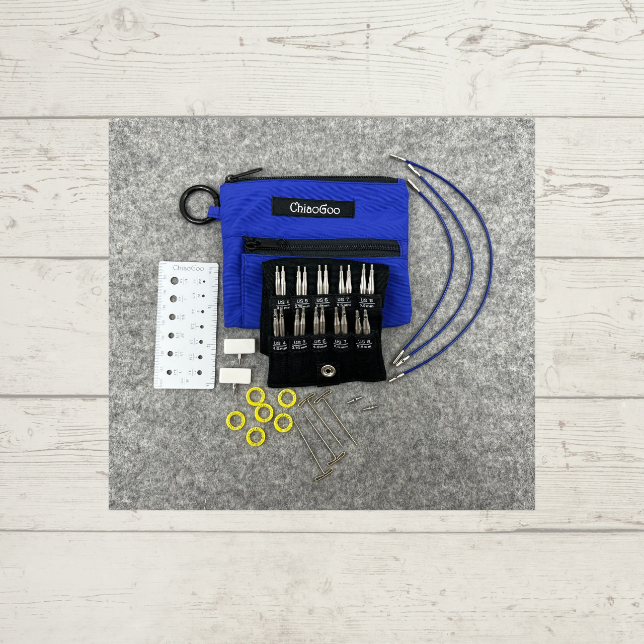 ChiaoGoo TWIST Shorties Interchangeable Knitting Needle Set, in blue (US 4-8), showing needle tips, cables, end stoppers, tightening keys, connectors, stitch markers, and needle gauge
