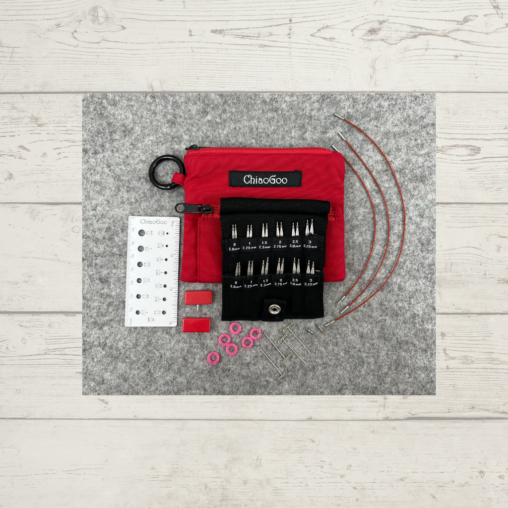 ChiaoGoo TWIST Shorties Interchangeable Knitting Needle Set, in red (US 0-3), showing needle tips, cables, end stoppers, tightening keys, connectors, stitch markers, and needle gauge