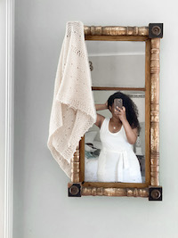 Mara Licole in a mirror with a knitted shawl