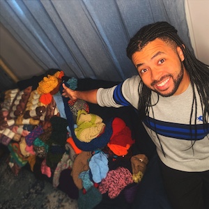 Austin Rivers with donations for Knit the Rainbow